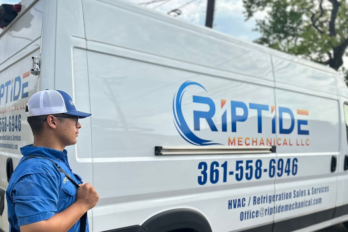 A branded Riptide Mechanical service van parked outside, the phone number and services readable on the side